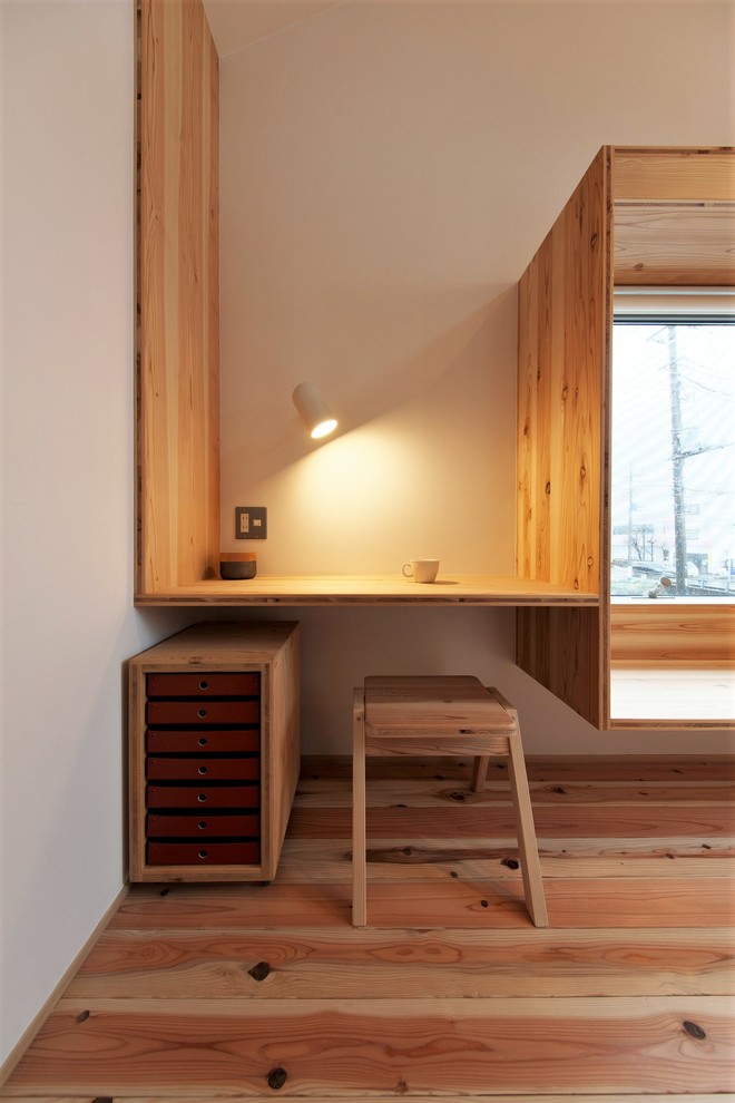 Modelo de salón abierto de estilo zen pequeño sin chimenea con paredes blancas, suelo de madera en tonos medios, televisor independiente y suelo marrón
