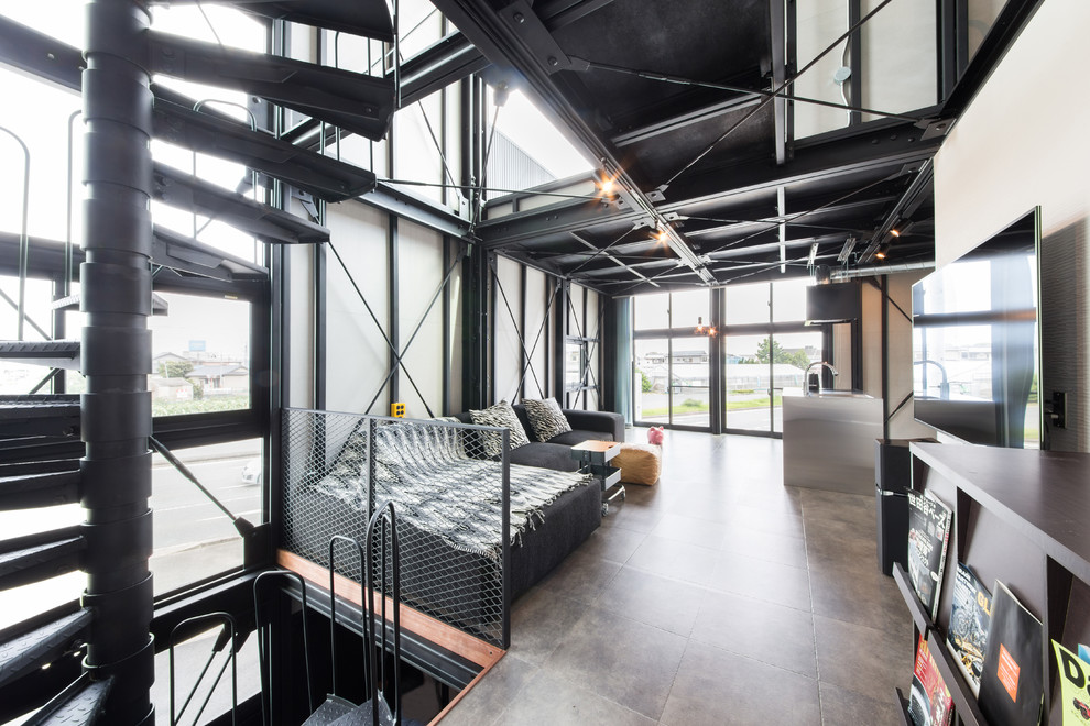 Foto di un soggiorno industriale di medie dimensioni e aperto con pareti bianche e pavimento grigio