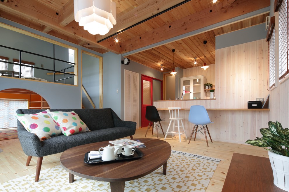 Skandinavisches Wohnzimmer mit blauer Wandfarbe und hellem Holzboden in Sonstige