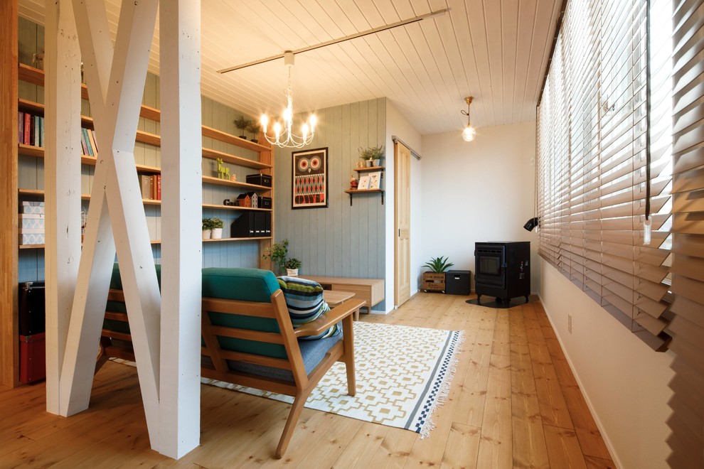Immagine di un soggiorno nordico con pareti blu, pavimento in legno massello medio e pavimento marrone