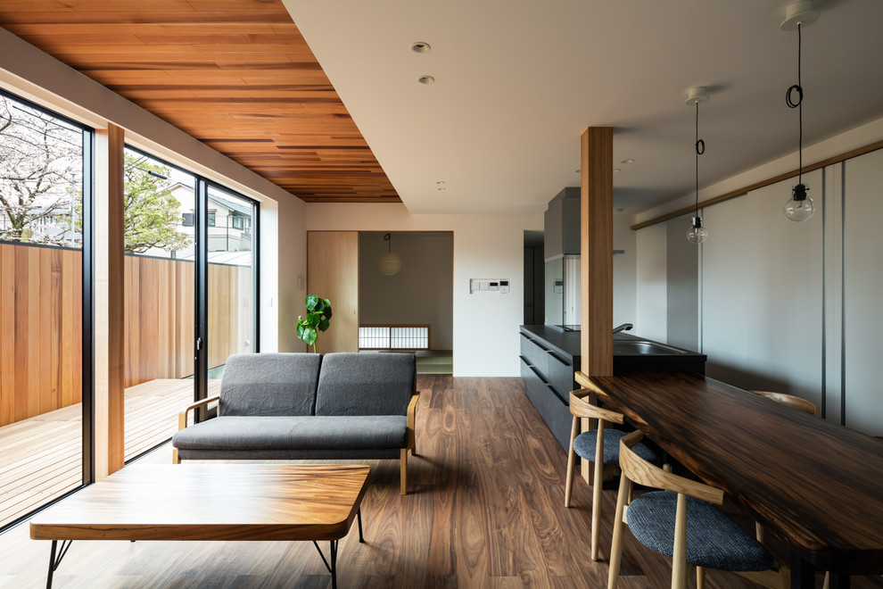 Living room - zen dark wood floor and brown floor living room idea in Osaka with white walls