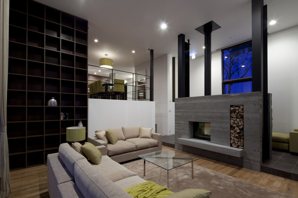 Contemporary open plan living room in Sapporo with white walls, light hardwood flooring, a standard fireplace and a concrete fireplace surround.