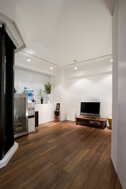 Foto di un soggiorno minimalista di medie dimensioni e chiuso con angolo bar, pareti bianche, parquet scuro, nessun camino e TV autoportante