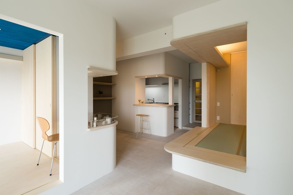 Diseño de salón abierto moderno pequeño sin chimenea con paredes blancas, suelo de corcho y suelo blanco