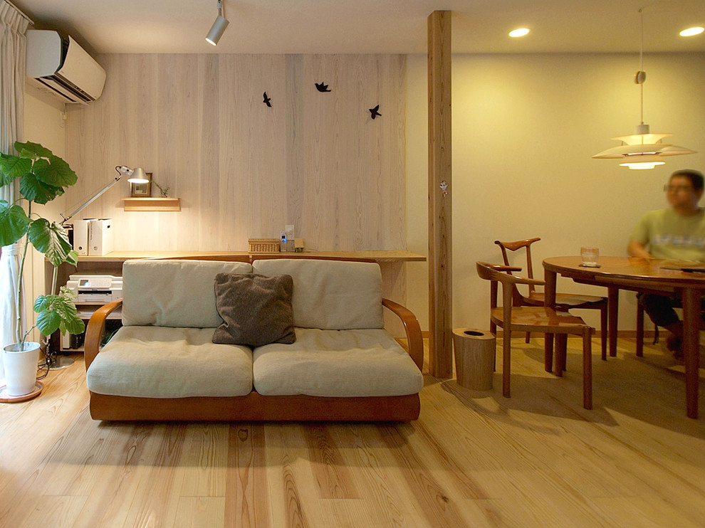 Danish open concept light wood floor and beige floor living room photo in Other with white walls