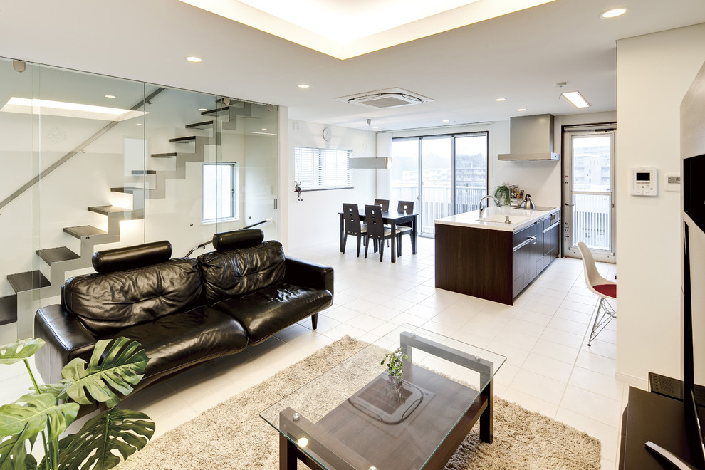 Foto di un soggiorno design aperto con pareti bianche, TV autoportante e pavimento bianco