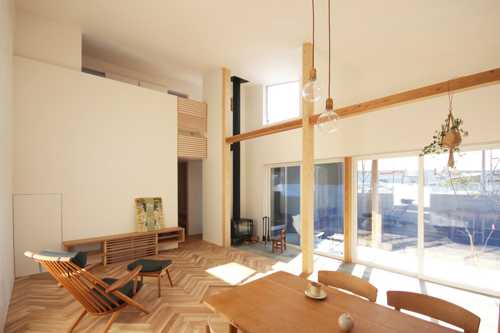Пример оригинального дизайна: гостиная комната в стиле модернизм с белыми стенами, паркетным полом среднего тона и коричневым полом