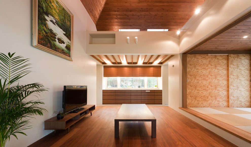 Idee per un soggiorno tradizionale con pareti bianche, pavimento in legno massello medio e TV autoportante