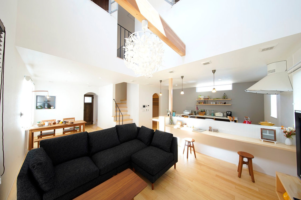 Living room - scandinavian open concept light wood floor and beige floor living room idea in Other with white walls