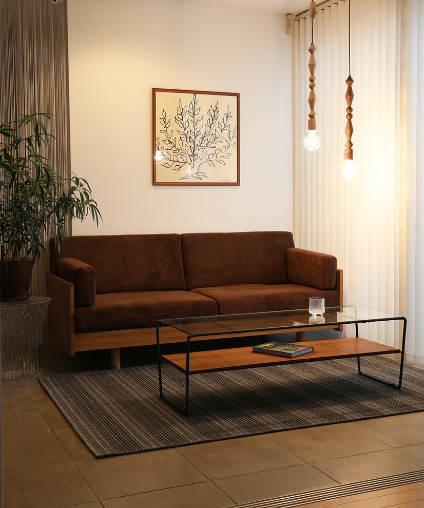 Example of an urban medium tone wood floor living room design in Other with white walls and no fireplace