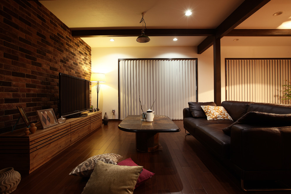 Example of an urban brown floor living room design in Other with brown walls and a tv stand