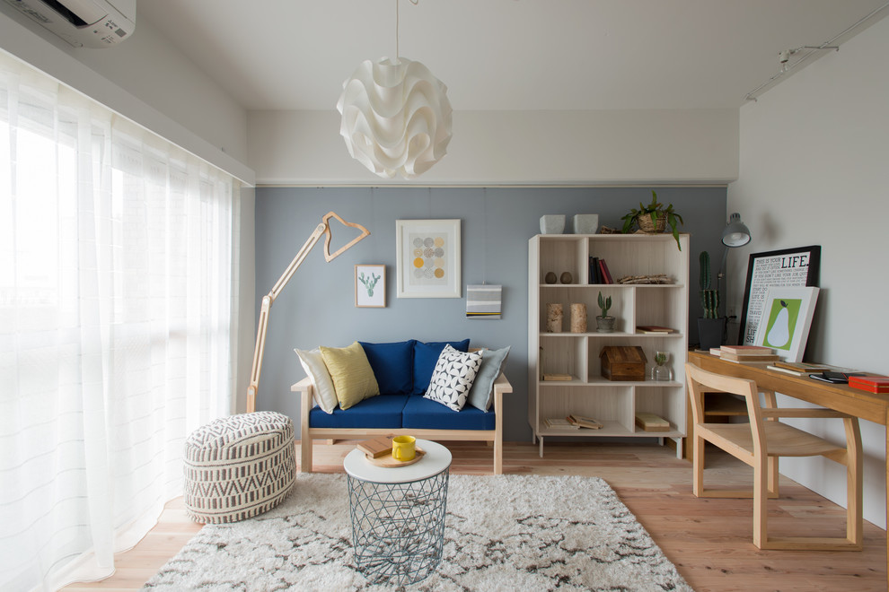 Ejemplo de salón para visitas abierto nórdico con paredes azules y suelo de madera clara