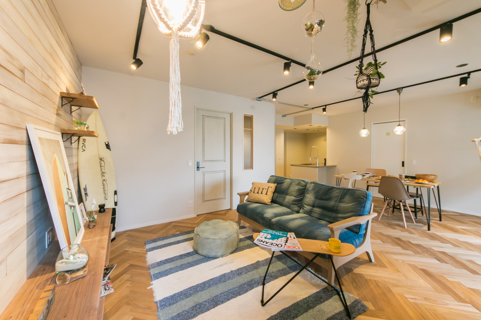 Beach style open plan living room in Other with multi-coloured walls, medium hardwood flooring and brown floors.