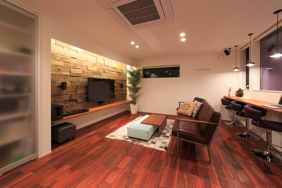 Свежая идея для дизайна: изолированная гостиная комната в современном стиле с белыми стенами, деревянным полом, телевизором на стене, красным полом и коричневым диваном - отличное фото интерьера