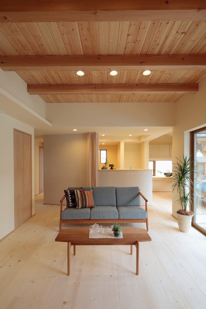 Example of an asian wood ceiling living room design in Other