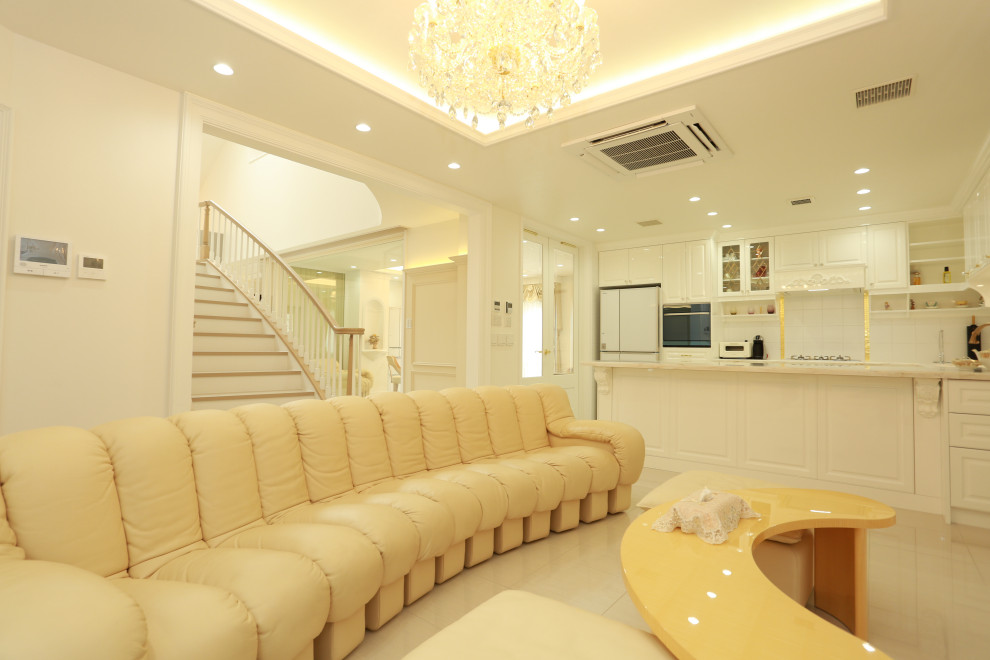 This is an example of an expansive victorian formal open plan living room in Osaka with beige walls, marble flooring, no fireplace, a wall mounted tv, beige floors, wallpapered walls and a drop ceiling.