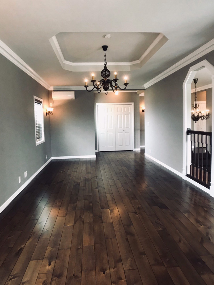 Large vintage formal open plan living room in Other with grey walls, dark hardwood flooring, no fireplace, a freestanding tv, brown floors, a wallpapered ceiling and wallpapered walls.
