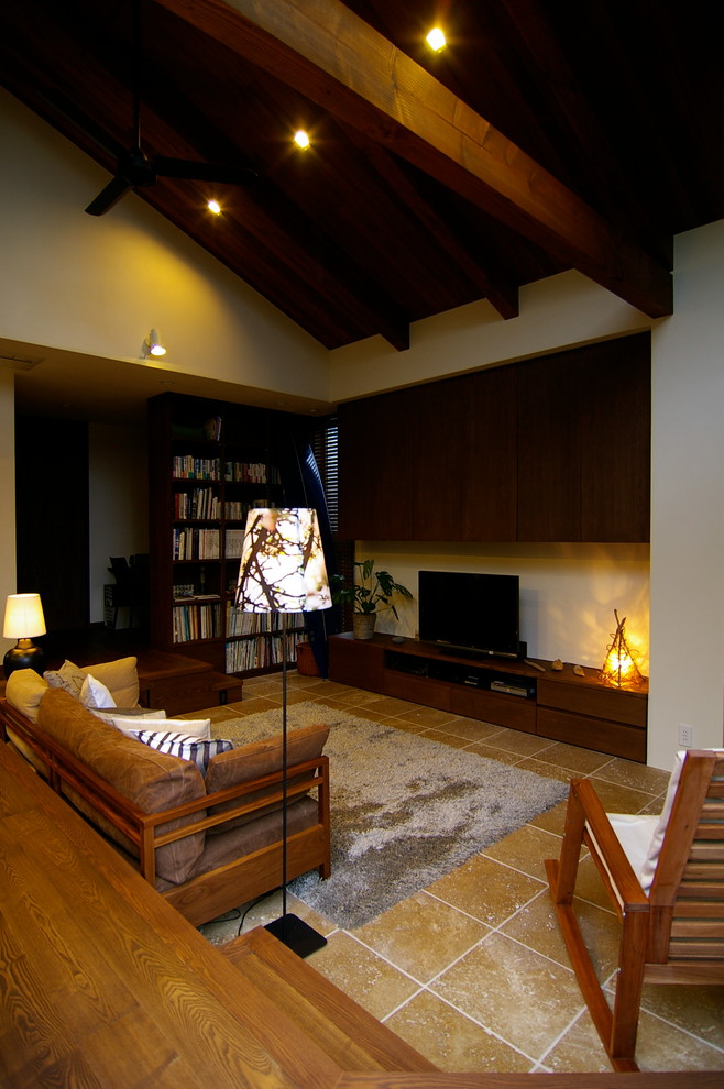 他の地域にあるミッドセンチュリースタイルのおしゃれなLDK (白い壁、トラバーチンの床、薪ストーブ、石材の暖炉まわり、ベージュの床) の写真