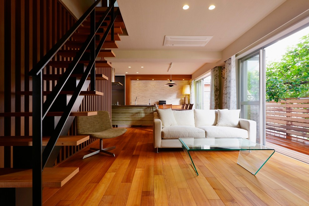 This is an example of a world-inspired open plan living room in Tokyo Suburbs with no fireplace.