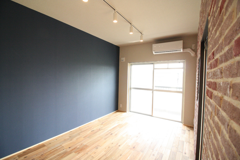 Foto di un soggiorno industriale con pareti blu e pavimento in legno massello medio