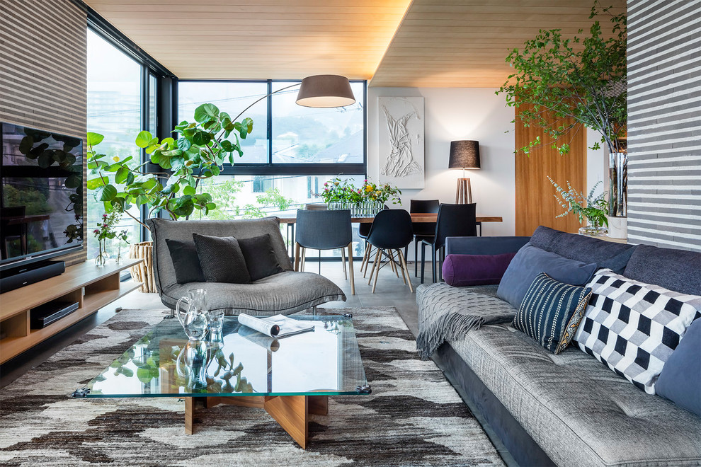 Example of a trendy open concept living room design in Kobe with white walls and a tv stand