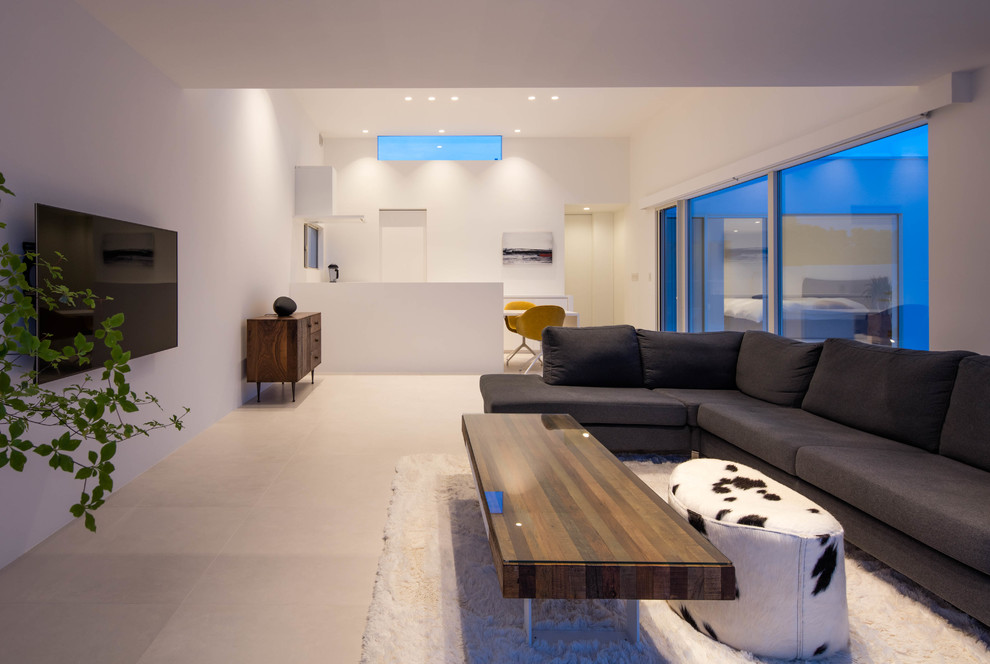 This is an example of a large modern open plan living room in Other with white walls, ceramic flooring, a wall mounted tv and white floors.