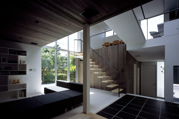 This is an example of a modern enclosed living room in Other with brown walls, porcelain flooring and black floors.