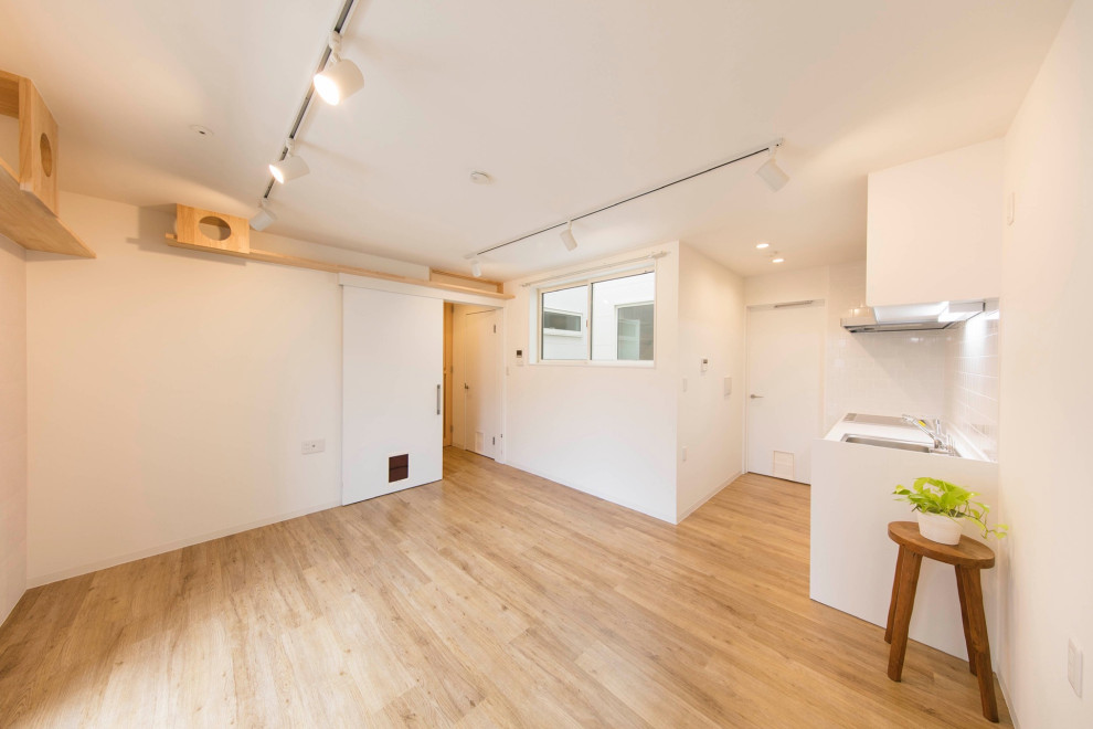 Cette photo montre un petit salon scandinave ouvert avec un mur blanc, parquet clair, un sol beige, un plafond en papier peint et un mur en parement de brique.