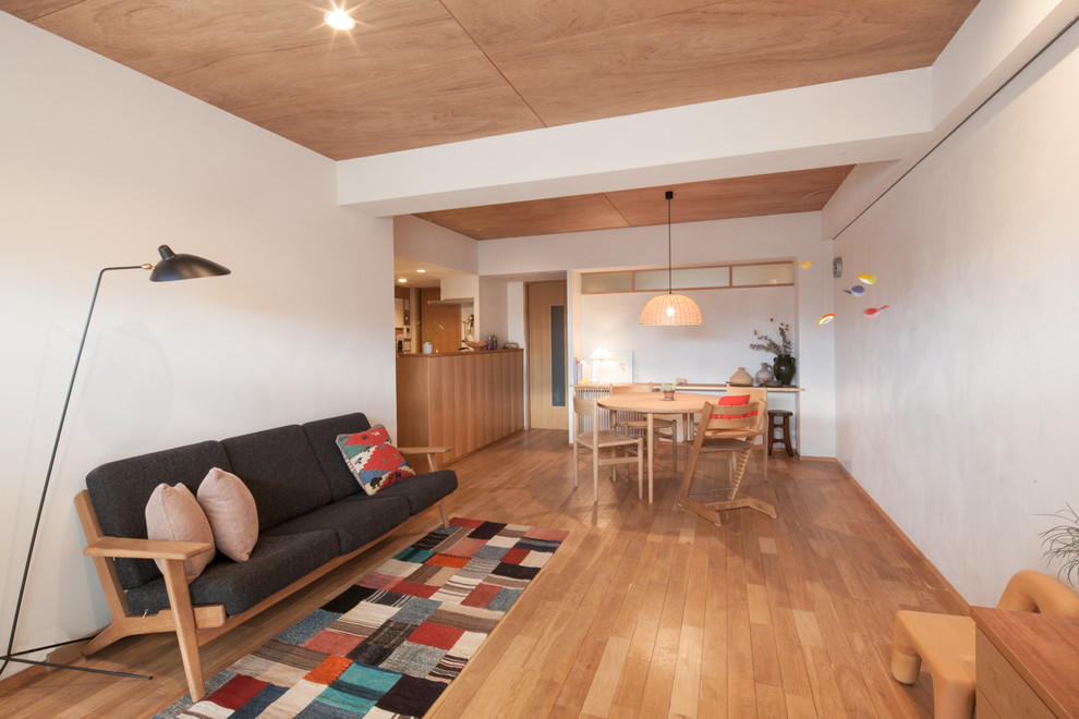Идея дизайна: открытая гостиная комната в скандинавском стиле с белыми стенами и паркетным полом среднего тона