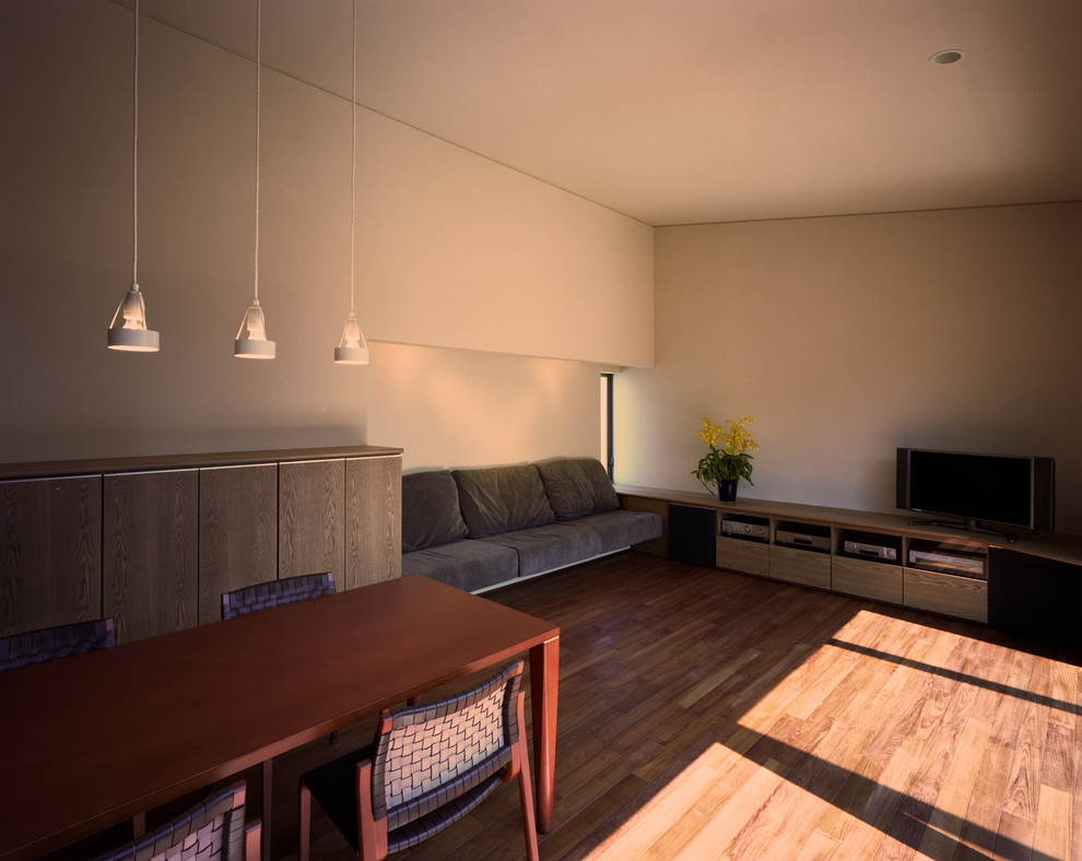 Mid-sized open concept medium tone wood floor and brown floor living room photo in Tokyo with white walls, no fireplace, a plaster fireplace and a tv stand