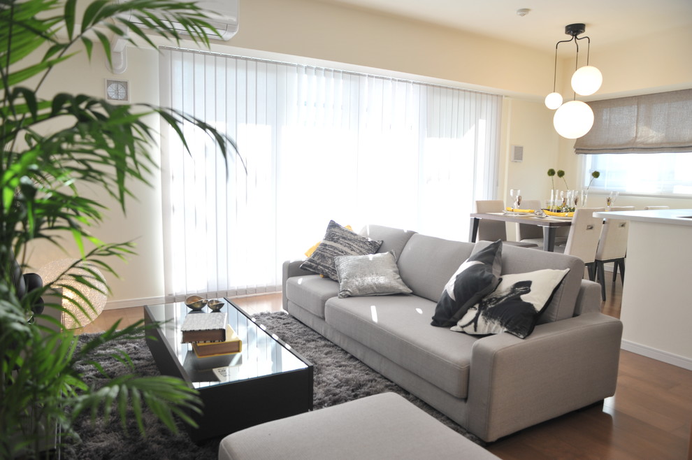 Inspiration pour un salon design ouvert avec un mur blanc, un sol en bois brun, un téléviseur indépendant et un sol marron.