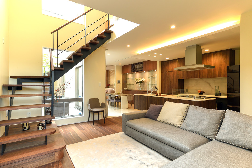 Photo of a large modern open plan living room in Kyoto with white walls, dark hardwood flooring and brown floors.