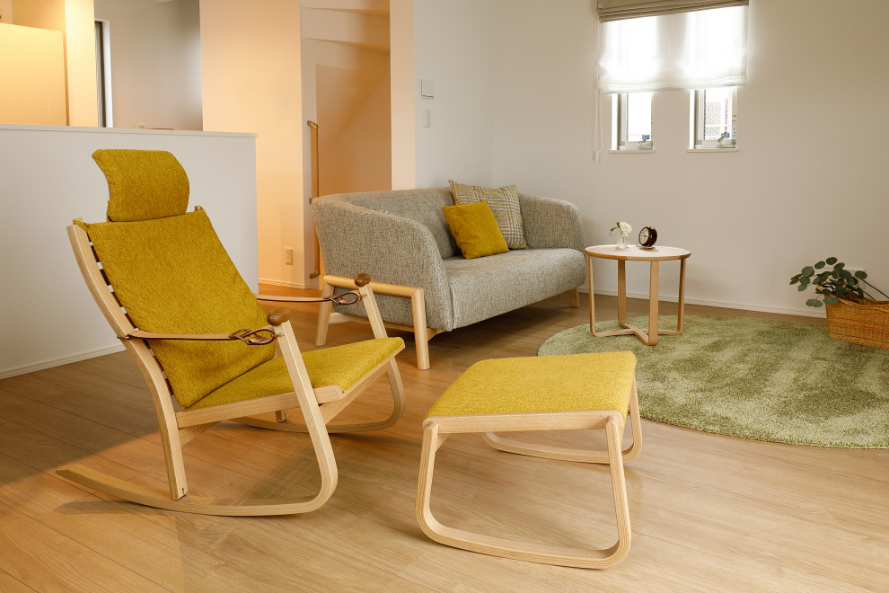 This is an example of a medium sized scandinavian living room in Tokyo with white walls, plywood flooring and beige floors.