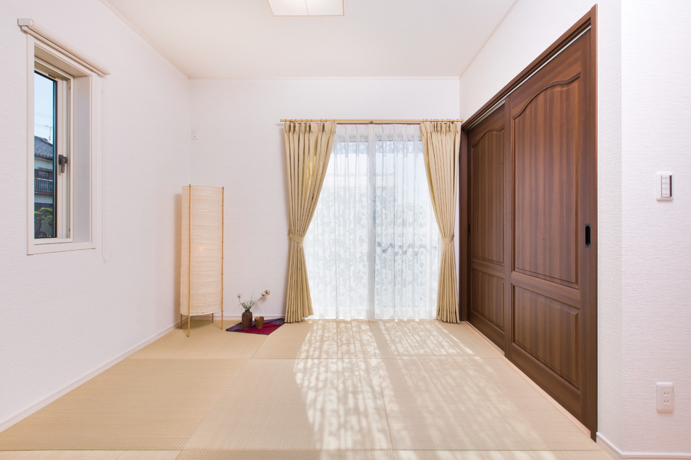 Nordisk inredning av ett vardagsrum, med beige väggar och tatamigolv