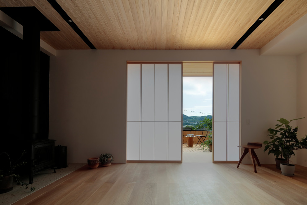 Example of a minimalist living room design in Other with a standard fireplace and a tile fireplace