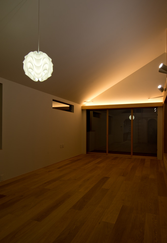 Idées déco pour un salon moderne de taille moyenne avec un mur blanc, parquet clair et un sol beige.
