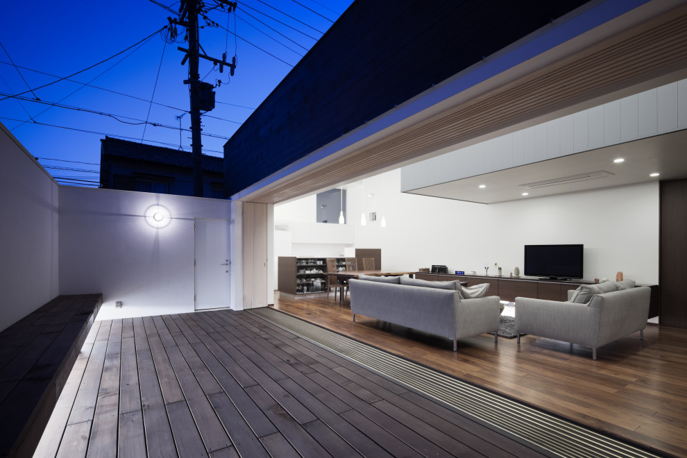 Inspiration for a modern open plan living room in Nagoya with white walls, painted wood flooring and brown floors.