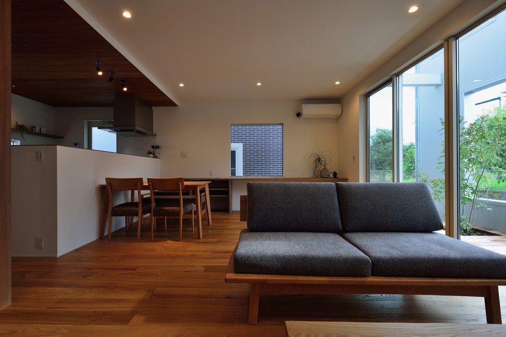 Idées déco pour un petit salon rétro ouvert avec un mur blanc, un sol en bois brun, un téléviseur indépendant et un sol beige.