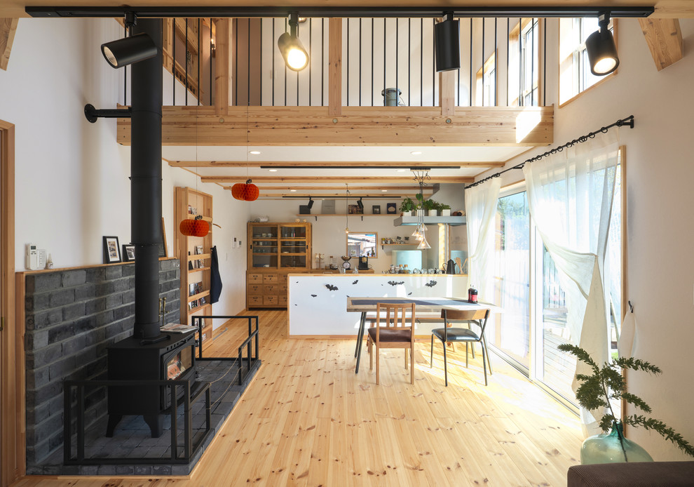 Offenes Asiatisches Wohnzimmer mit weißer Wandfarbe, hellem Holzboden und braunem Boden in Tokio