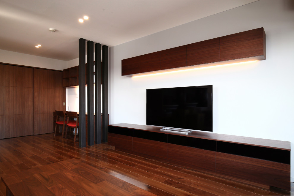 Idéer för ett mellanstort modernt allrum med öppen planlösning, med vita väggar, mörkt trägolv och en fristående TV