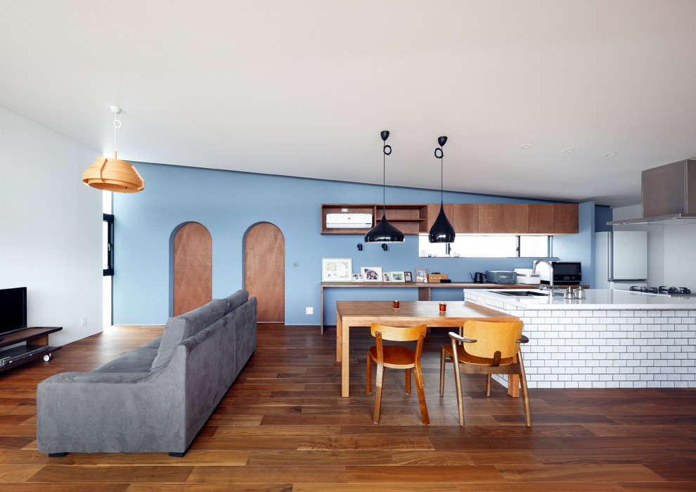 Modelo de salón abierto escandinavo con paredes multicolor, suelo de madera en tonos medios, televisor independiente y suelo marrón