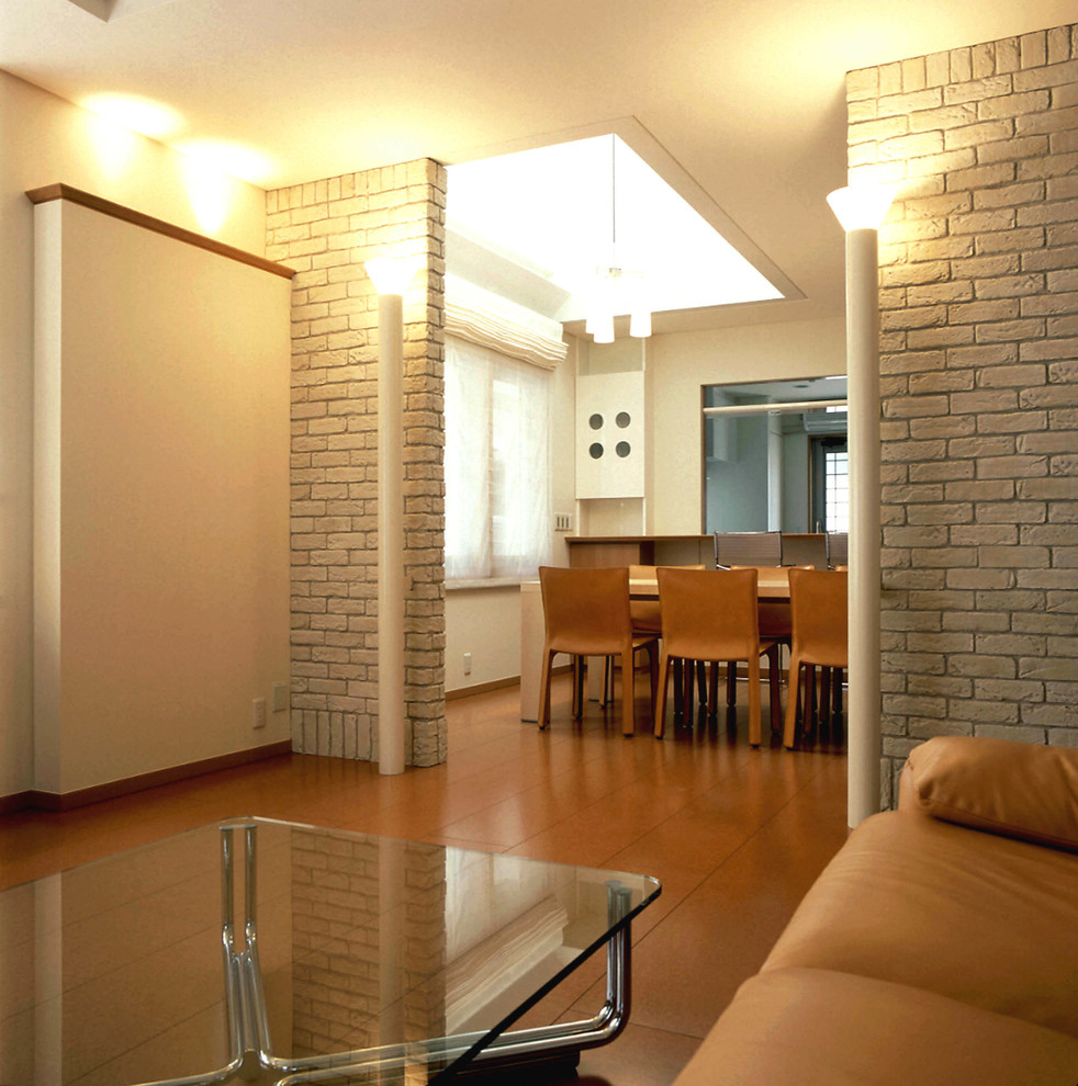 Modelo de salón para visitas abierto contemporáneo con paredes blancas, suelo de corcho y suelo marrón