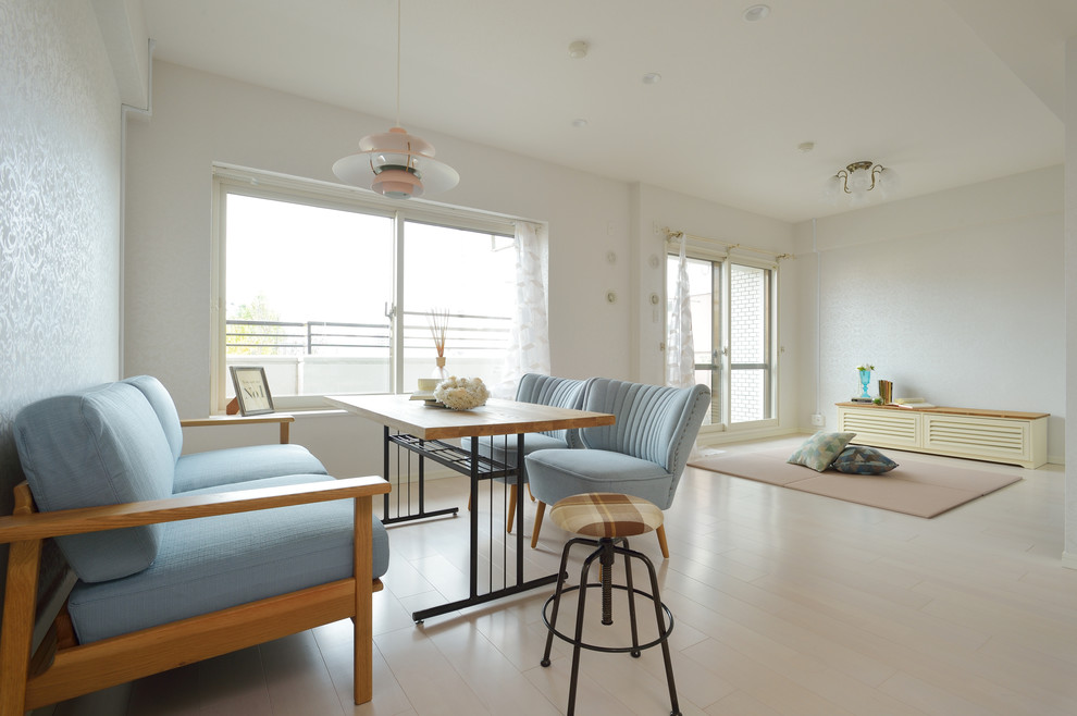 This is an example of a scandi living room in Other with white walls, a freestanding tv, white floors and painted wood flooring.