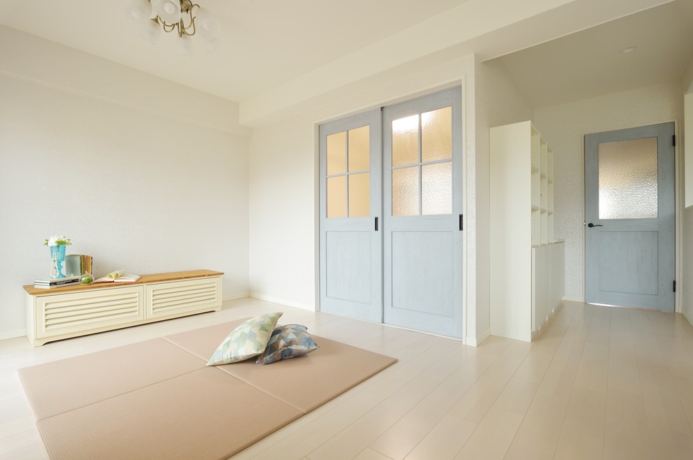 Cette photo montre un salon scandinave avec un mur blanc, un téléviseur indépendant et un sol blanc.