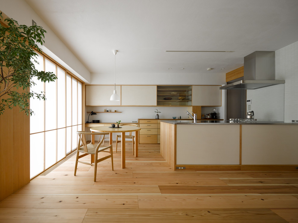 Scandinavian open plan living room in Other with light hardwood flooring and no fireplace.