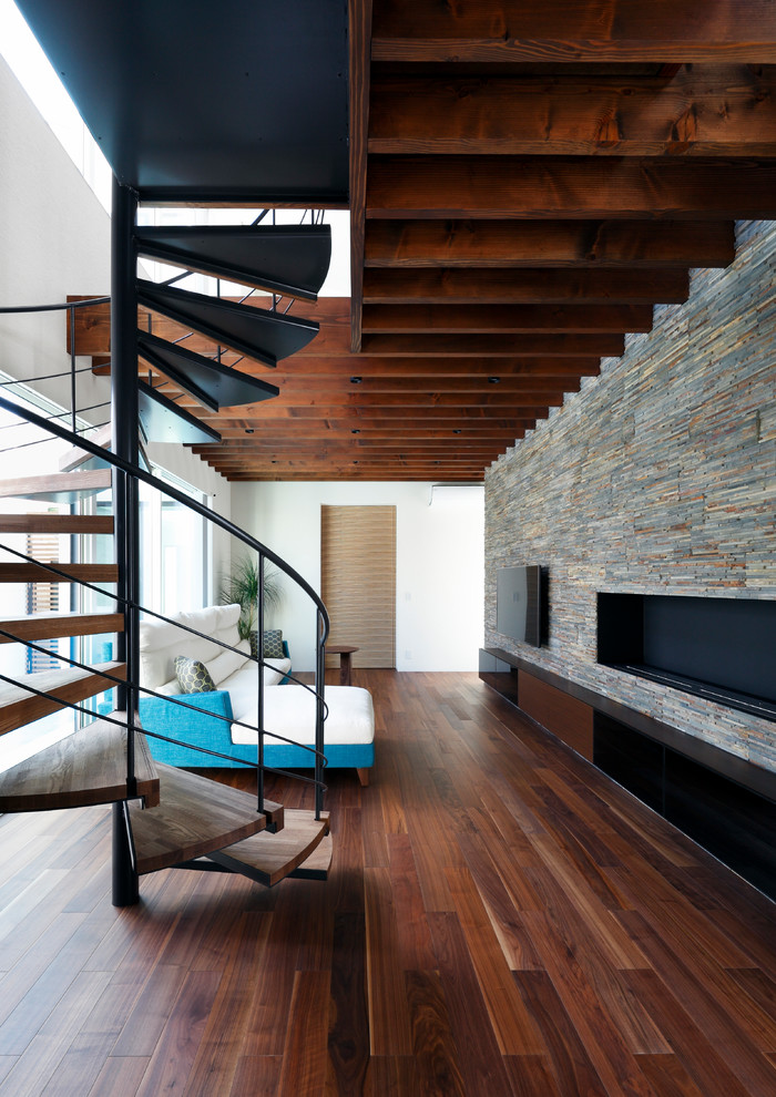 Esempio di un soggiorno moderno aperto con TV a parete, pareti multicolore, parquet scuro e pavimento marrone