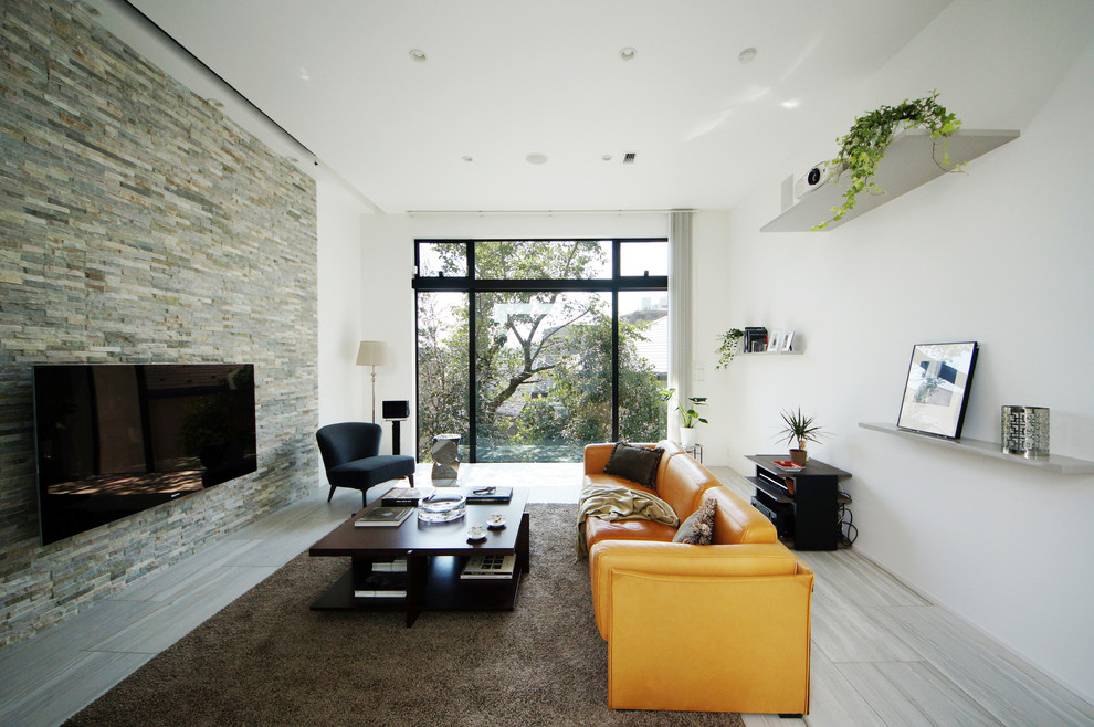 Example of a mid-sized trendy enclosed light wood floor living room design in Tokyo with white walls, no fireplace and a wall-mounted tv