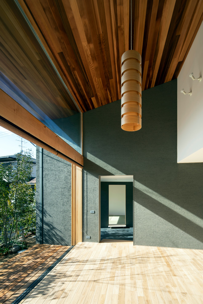 Fernseherloses Wohnzimmer mit grauer Wandfarbe und braunem Holzboden in Osaka