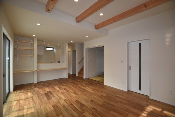 Example of a mid-sized asian open concept dark wood floor and brown floor living room design in Fukuoka with white walls
