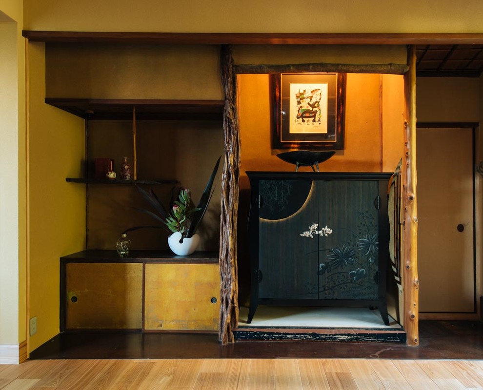 Example of a large zen formal and open concept tatami floor and black floor living room design in Other with beige walls, a two-sided fireplace and a wood fireplace surround